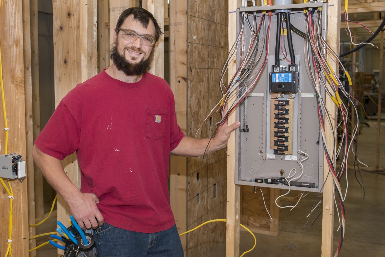 Shawn Graupmann standing next to an electrical box