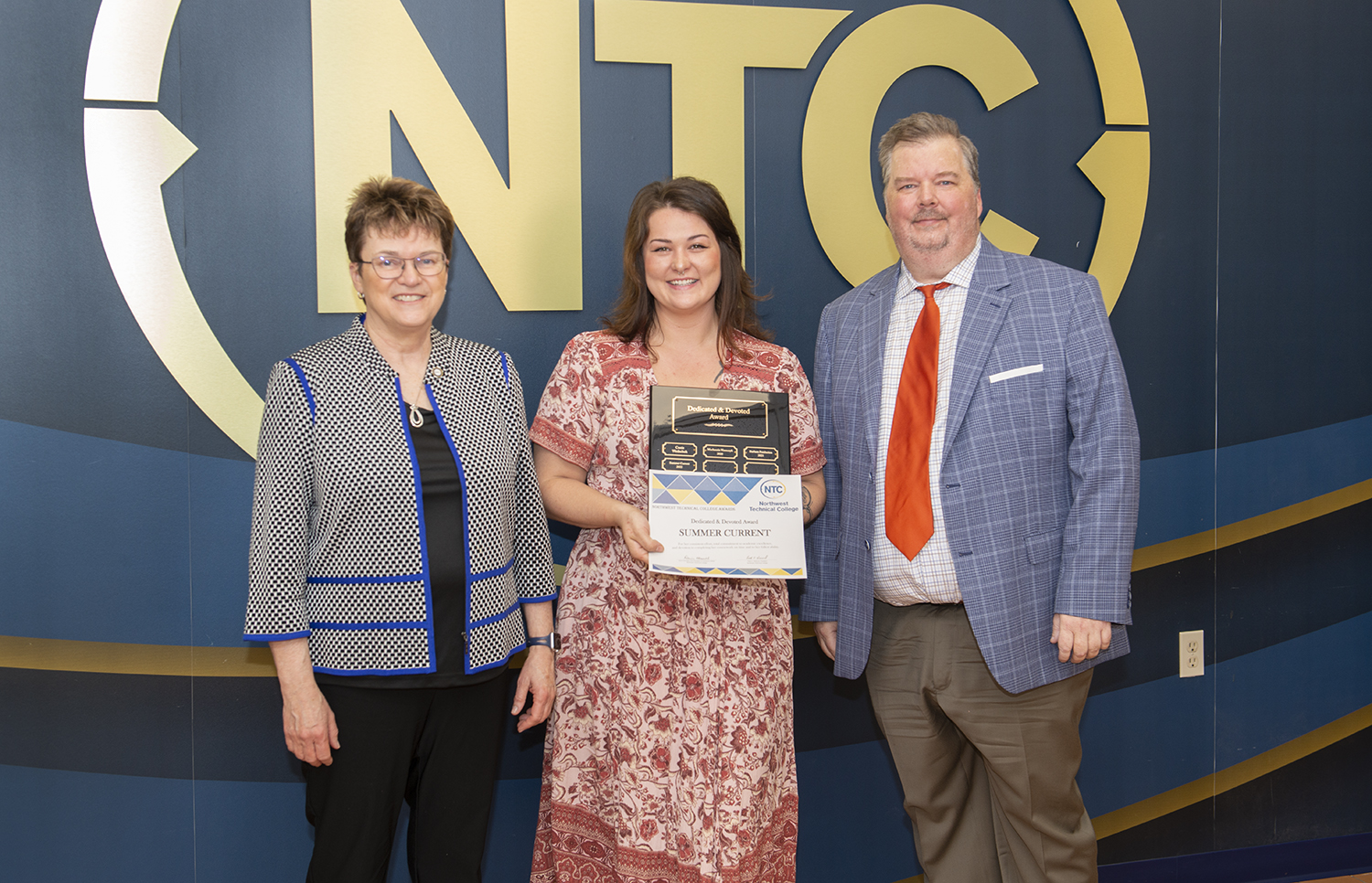 Summer Current holding her dedicated and devoted student award and plaque.