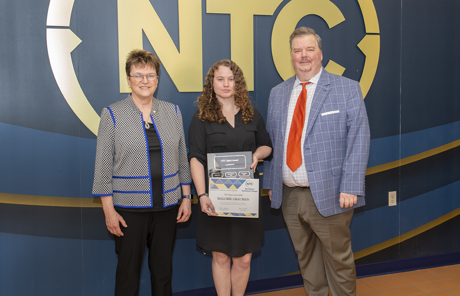 Malorie Grauman holding her NTC spirit award and plaque.