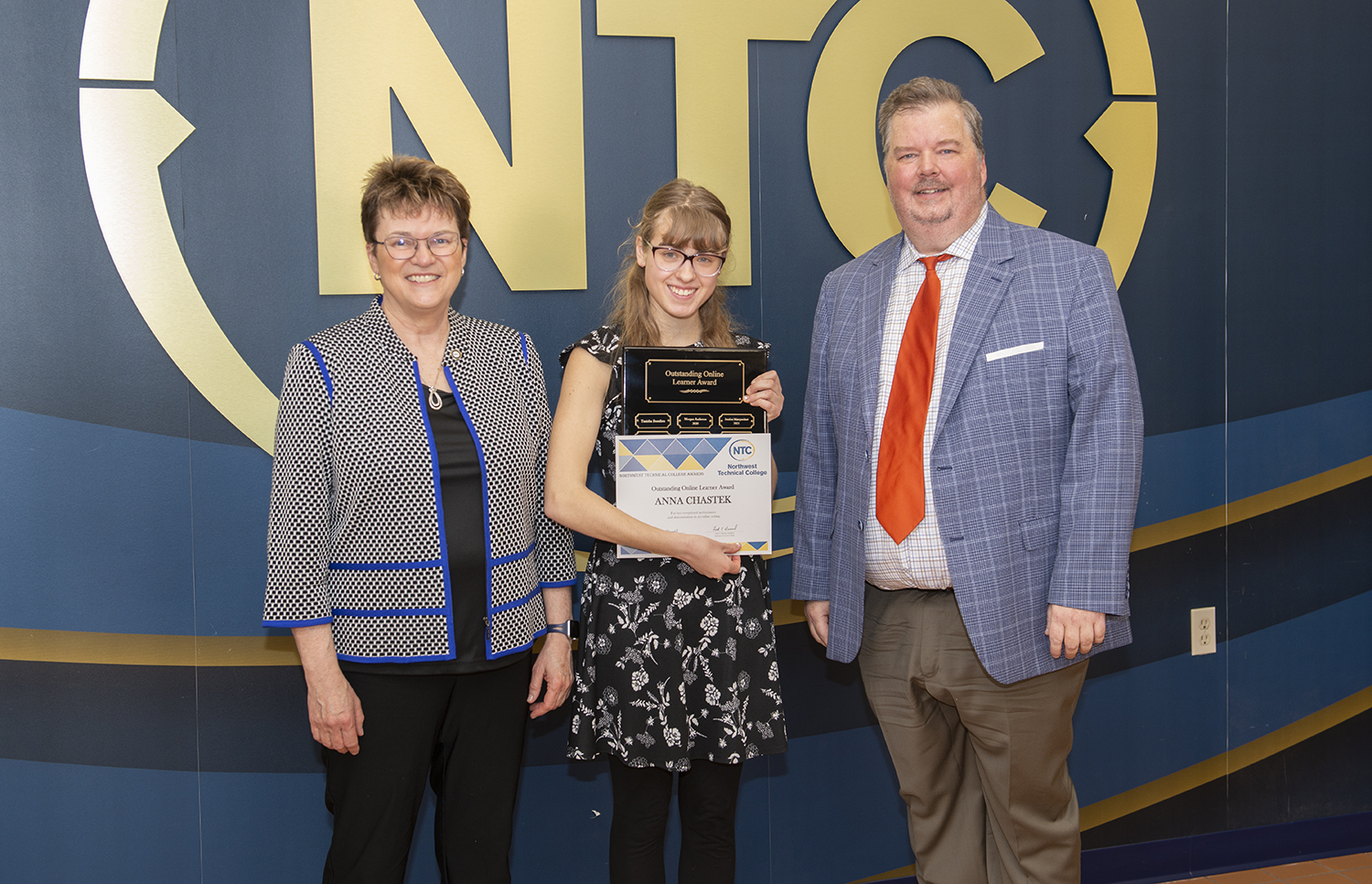 Anna Chastek holding her online student award and plaque.
