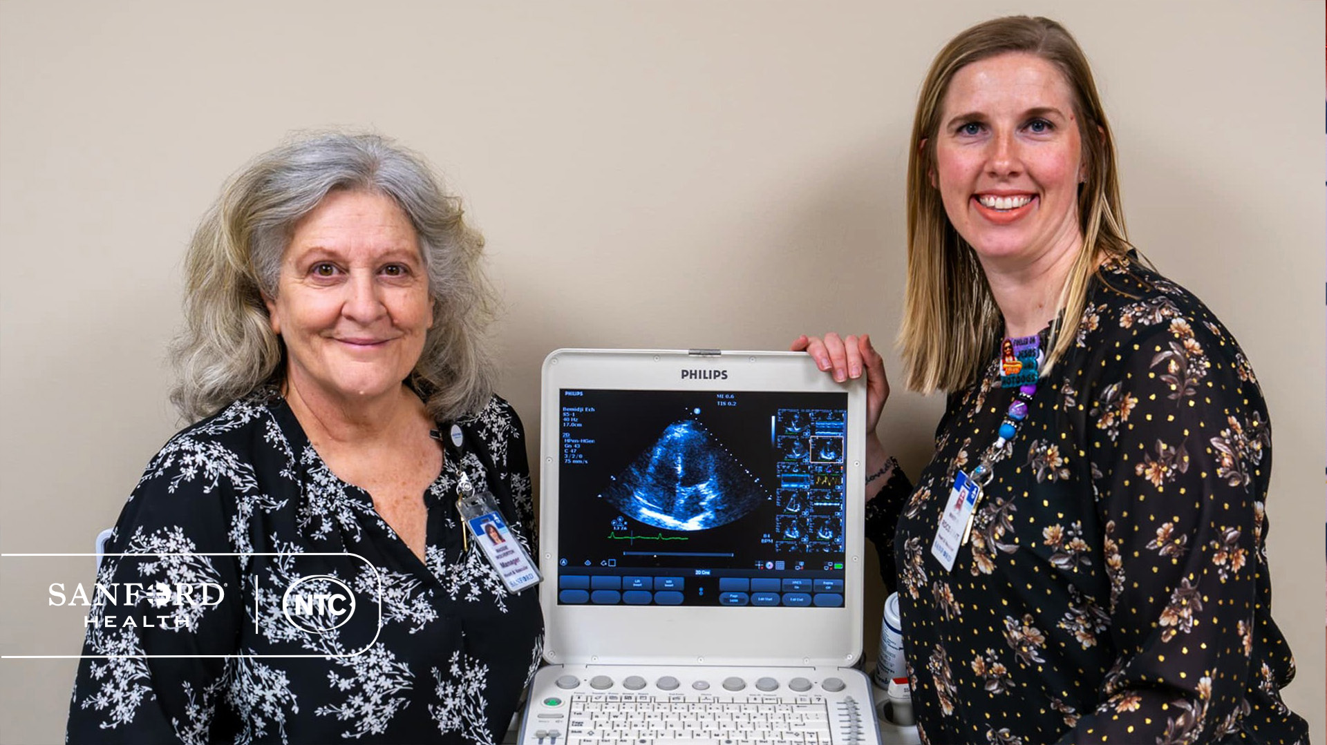 Maggie Wolverton and Mindy Williams stand next to a Philips sonography machine.