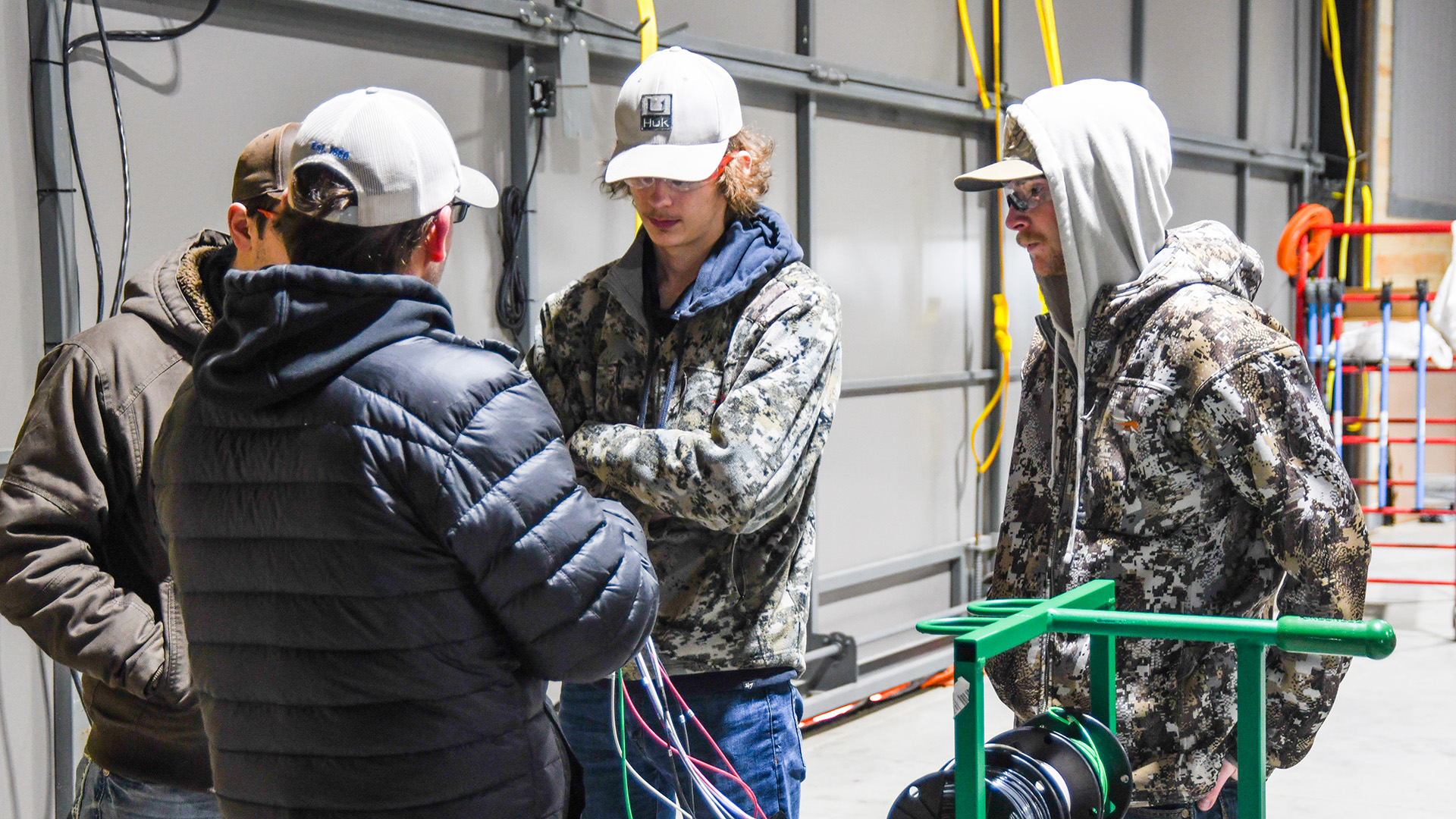 NTC students bundle wires to prepare for a cable pull at the North STAR Robotics facility.