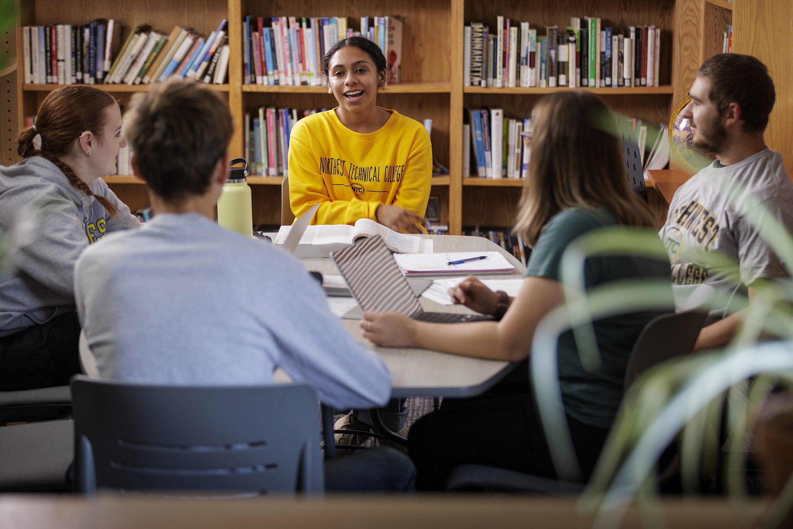 Students sitting in the NTC library, having a conversation