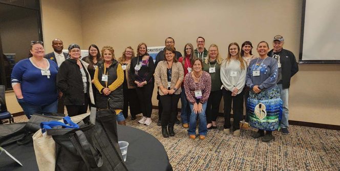 Large group posing at a conference.