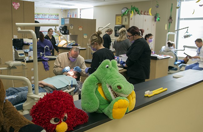 NTC student providing dental care during NTC's annual Give Kids a Smile free dental care event.