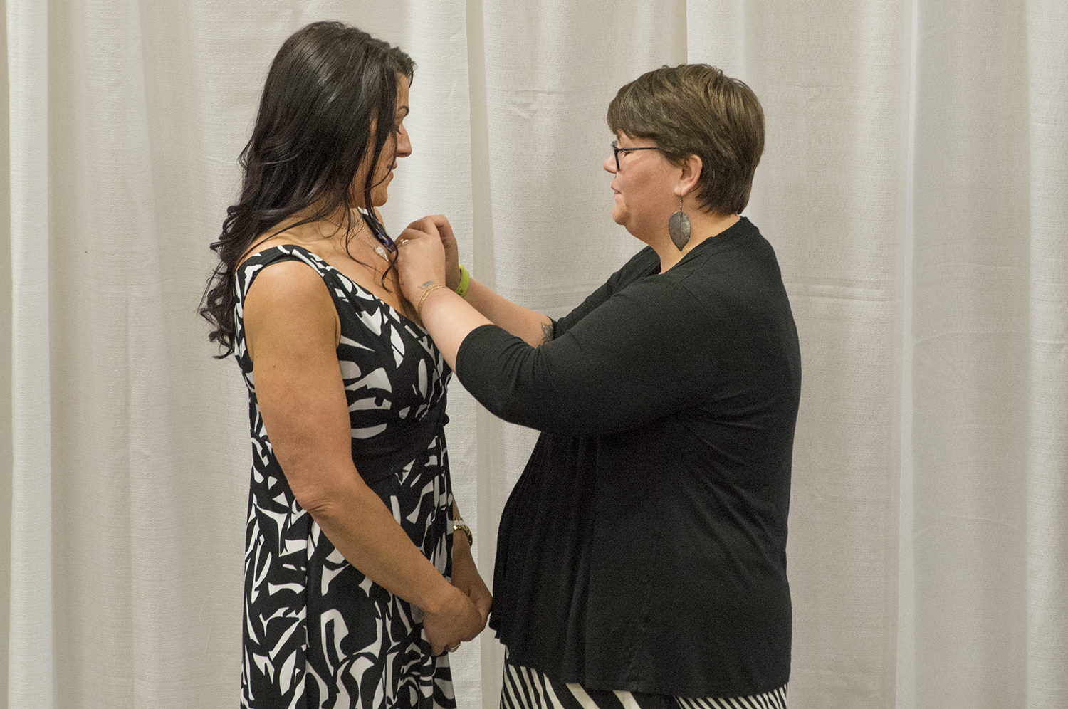 Ashley Anderson pinning a nursing student at the NTC Nurse Pinning Ceremony.