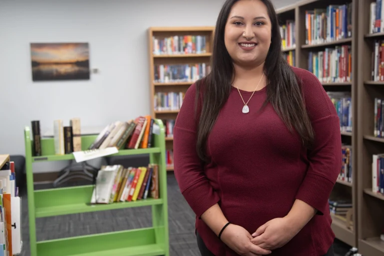 a woman smiling in a library