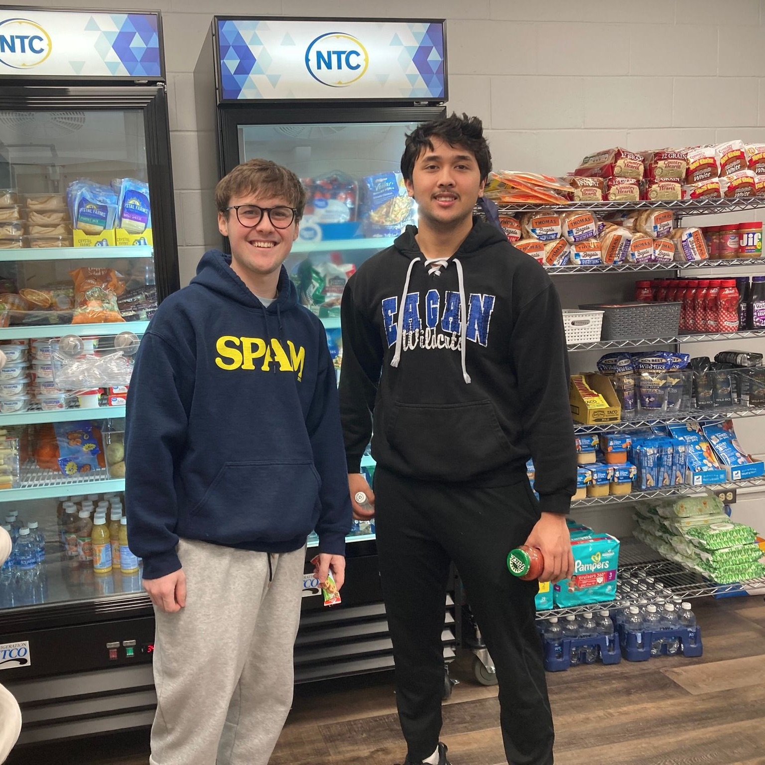Two NTC students standing inside the NTC market