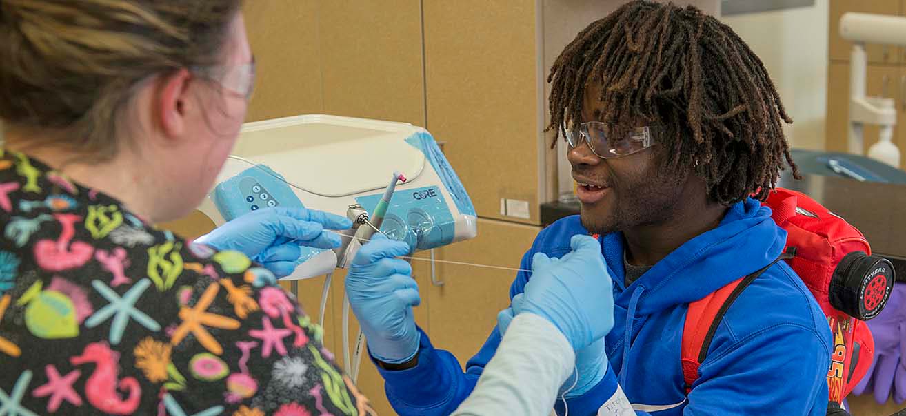 A student explores Dental Assisting at NTC's March 21 Passport to the Future event.