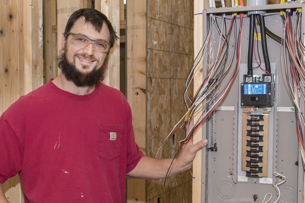 Shawn Graupmann standing next to an electrical box