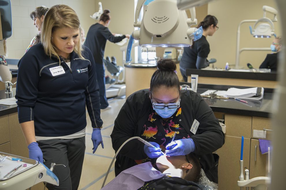 NTC Dental Assistant conducting a dental screening.