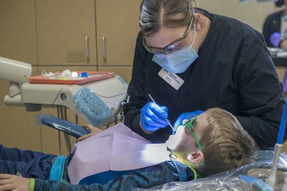 NTC Dental Assisting Program Provide Care to Nearly 50 Kids at Annual Give Kids a Smile NTC Dental Assistant conducting a dental screening.