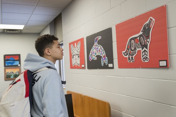 Area High School Students Showcase Artwork at NTC Student Success Center Student from Cass-Lake observing the artwork.