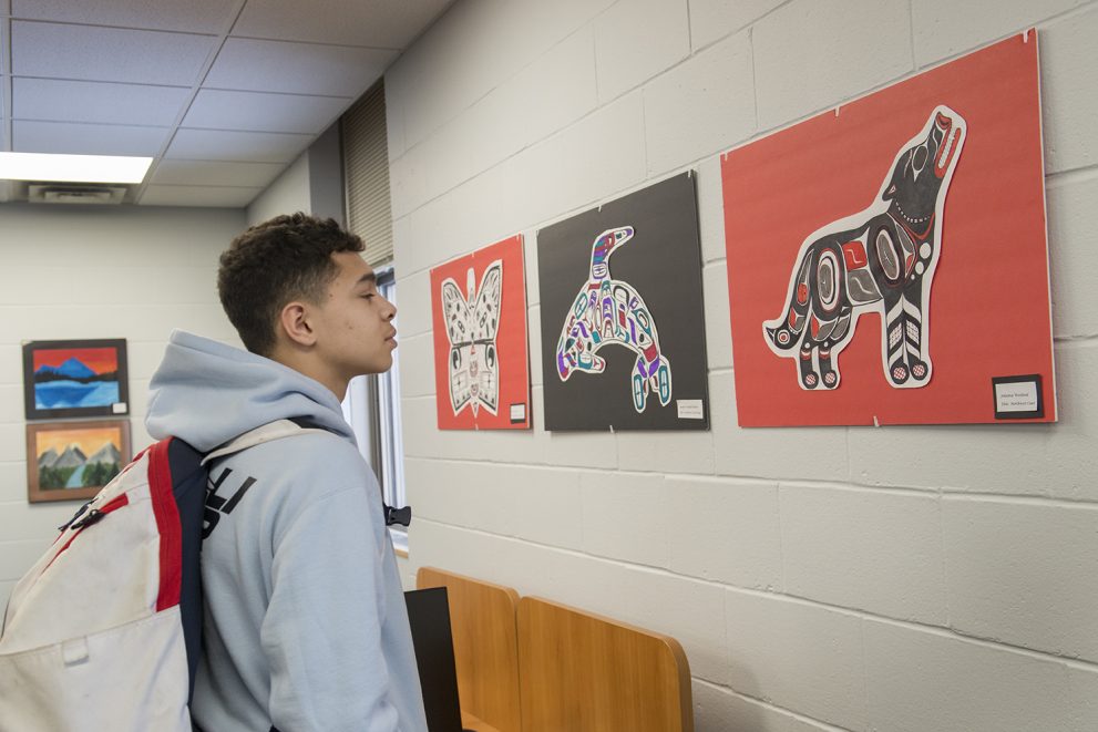 Student from Cass-Lake observing the artwork.