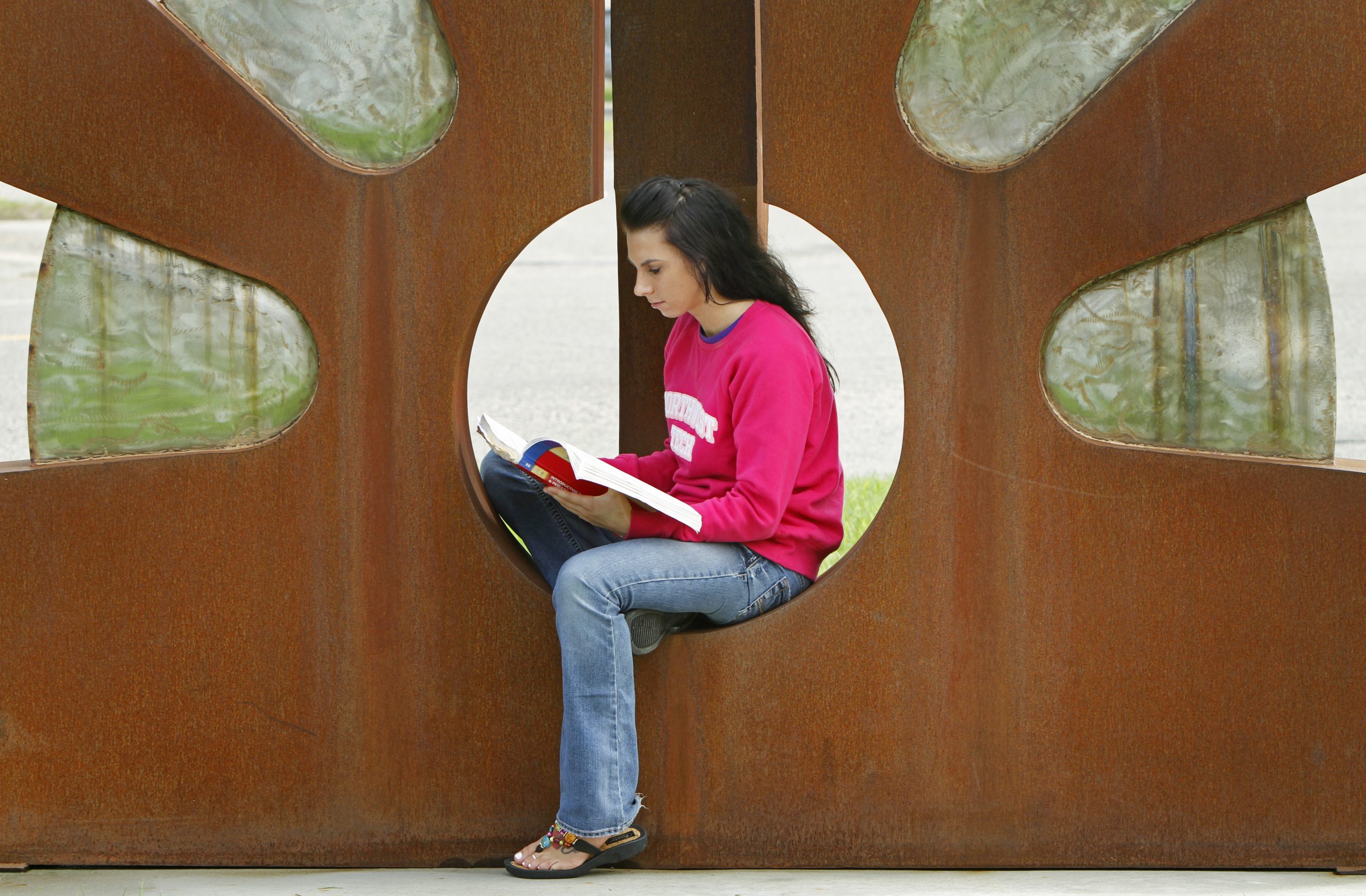 ntc student with the sculpture on campus