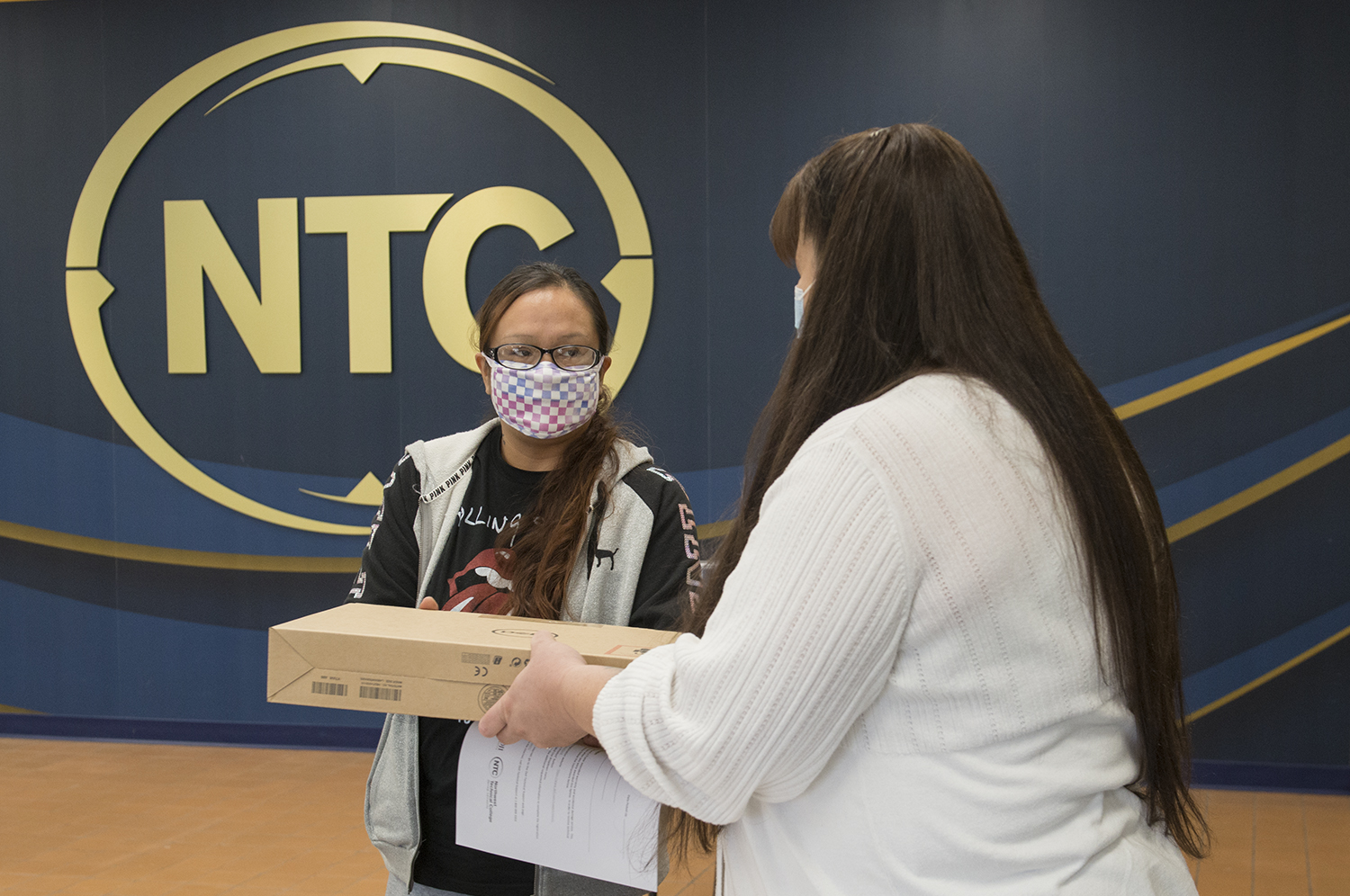 Chrissy Koch, executive director of the American Indian Resource Center, distributing Laptops to Students Awarded COVID-19 Relief Grants.