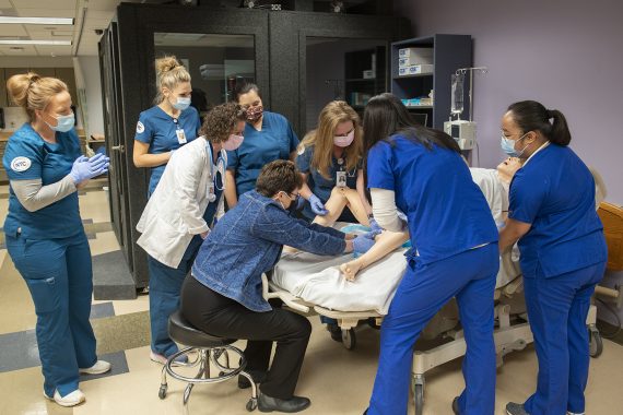 President Hensrud tours the nursing lab with students.
