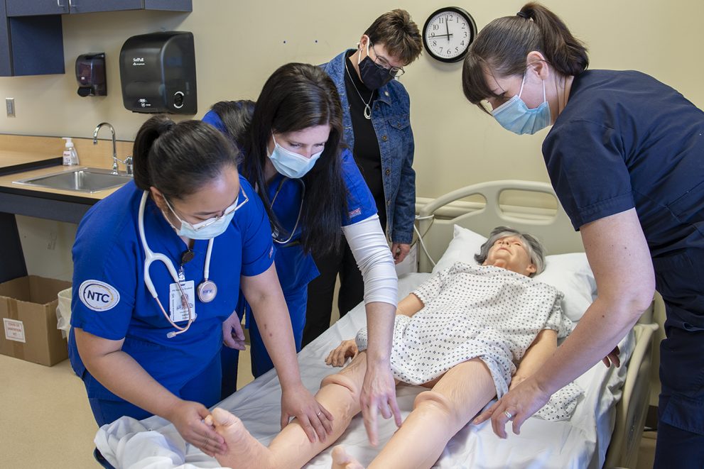 President Hensrud tours the updated nursing lab with students in April 2021.