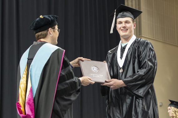 Northwest Technical College graduate receiving a diploma