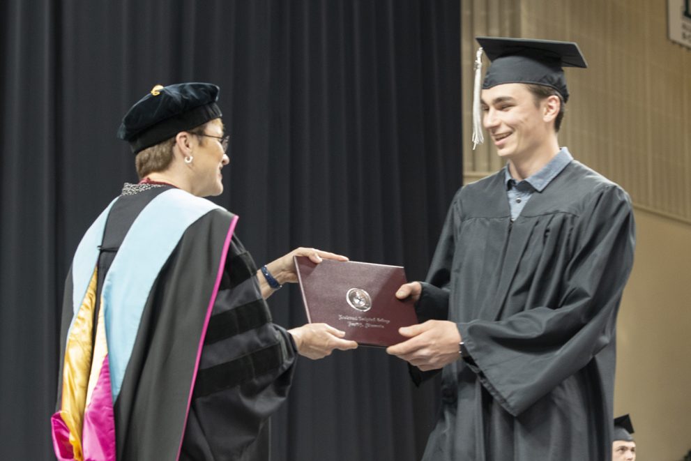 Northwest Technical College graduate receiving a diploma