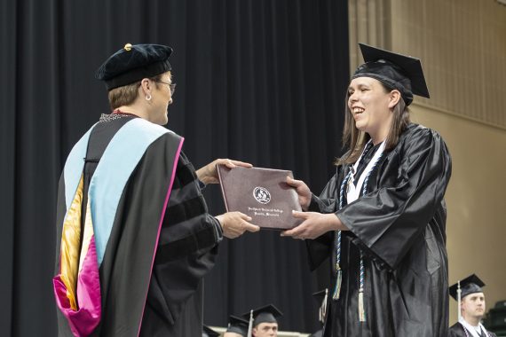 Northwest Technical College graduate receiving a diploma