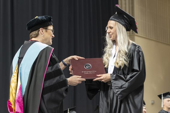 Northwest Technical College graduate receiving a diploma