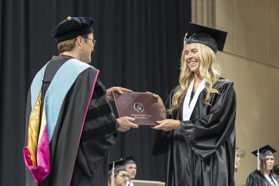 Northwest Technical College graduate receiving a diploma