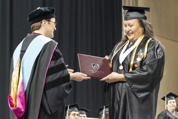 Northwest Technical College graduate receiving a diploma