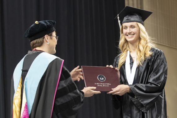 Northwest Technical College graduate receiving a diploma