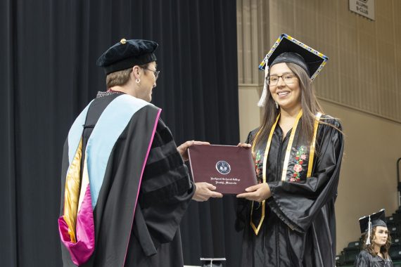 Northwest Technical College graduate receiving a diploma