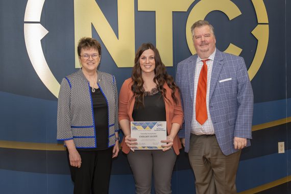 Chelsey Duffy holding her outstanding student award.