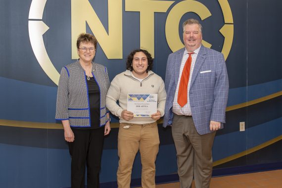 Erik Artiga holding his most improved student award.