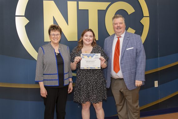 Shelby Kolu holding her outstanding student award.