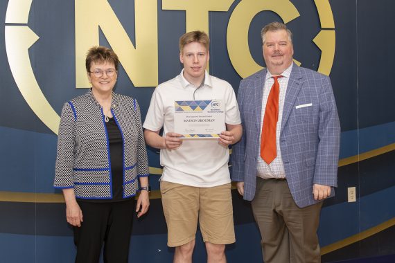 Mayson Skogman holding his most improved student award.