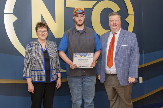 Steven Mayers holding his most improved student award.