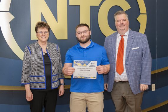 Beau Stiller holding his outstanding student award.