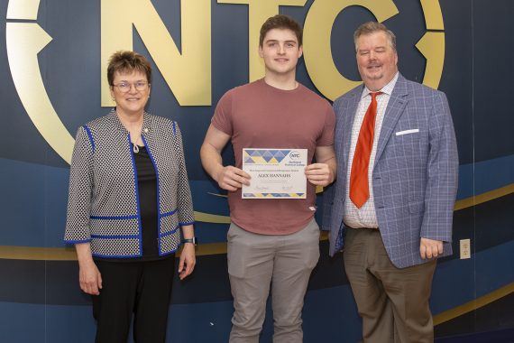 Alex Hannahs holding his most improved student award.