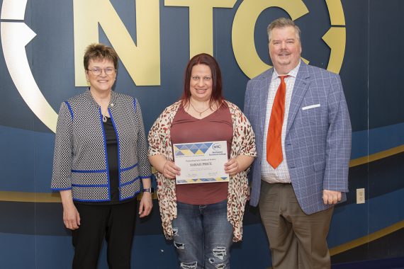 Sarah Price holding her outstanding student award.