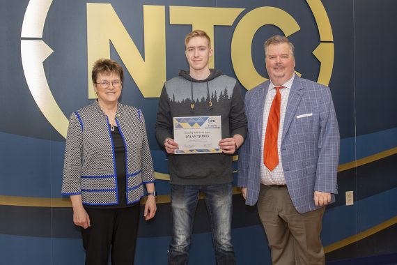 Dylan Tjepkes holding his outstanding student award.