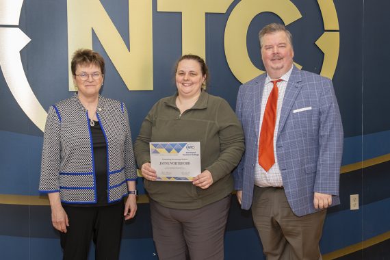 Jayne Whiteford holding her outstanding student award.