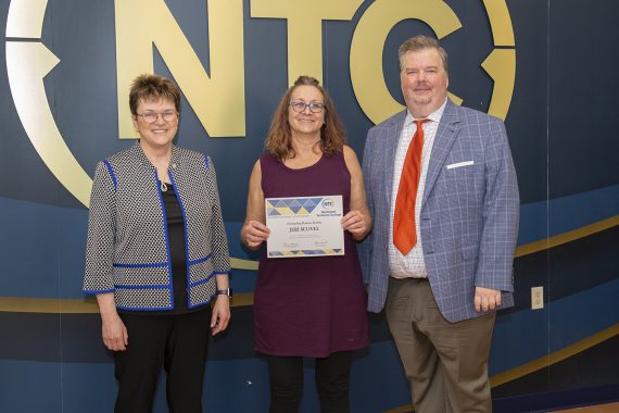 Jeri Scovel holding her outstanding student award.