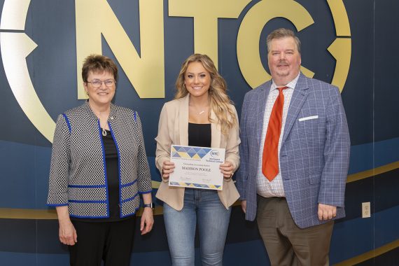 Madison Poole holding her outstanding student award.