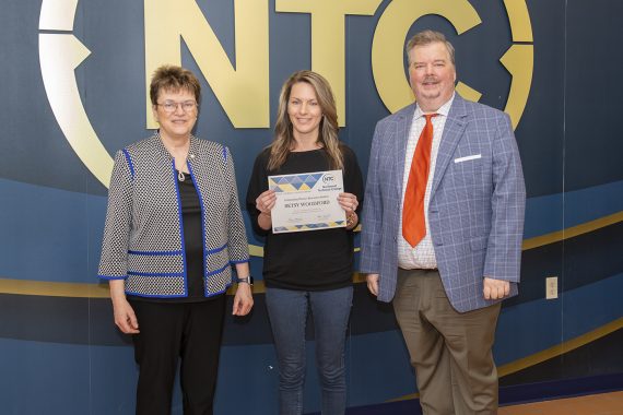 Betsy Woodford holding her outstanding student award.