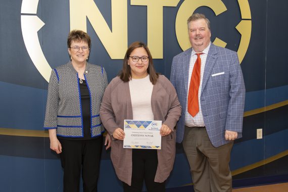 Cheyanne Novak holding her outstanding student award.