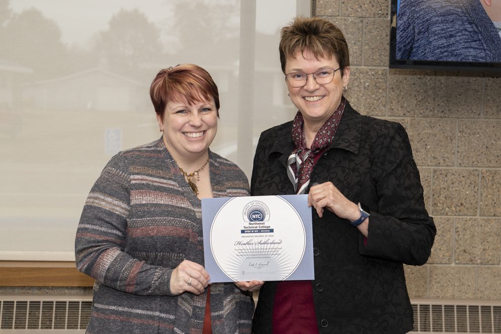 President Faith Hensrud presenting Heather Sutherland, early childhood education faculty, the Spirit of NTC award.