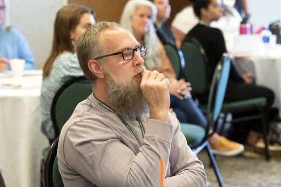 An attendee listening to a presentation during NTC's Fifth Annual Community Health Worker Conference