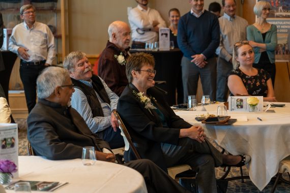 President Hensrud smiling while listening to Trustee Roger Moe