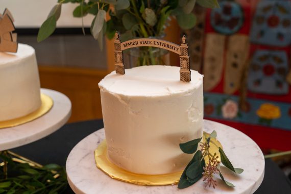 a locally made cake with a small wooden replica of the BSU arch