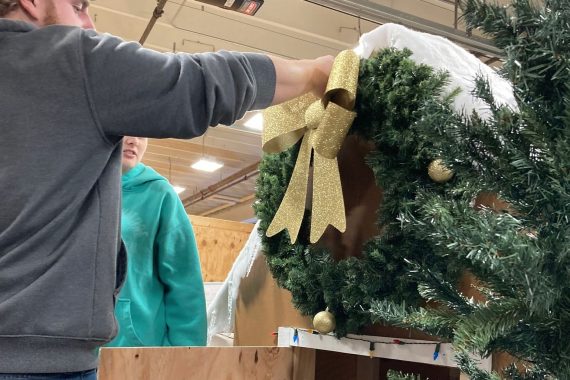 An NTC student helps construct a float for the Night We Light Parade in downtown Bemidji on Nov. 25