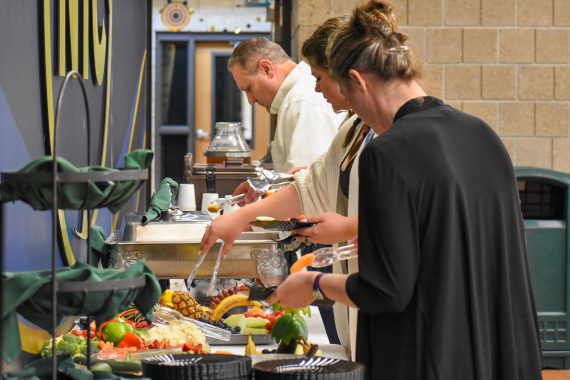 Attendees of the 50th anniversary of dental assisting celebration help themselves to food